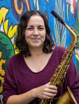 Jessika Smith, a white woman holding a saxophone