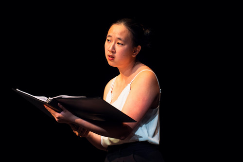 An Asian American actor reads from a script