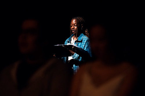 An African American woman reads from a script