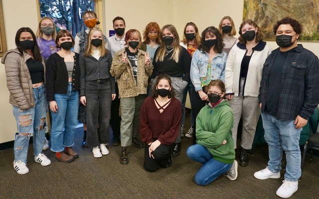 Sigma Tau Delta members posed for a picture in a classroom. Masks on.