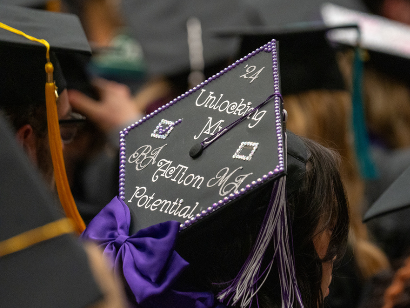 A student's decorated mortar board cap at graduation