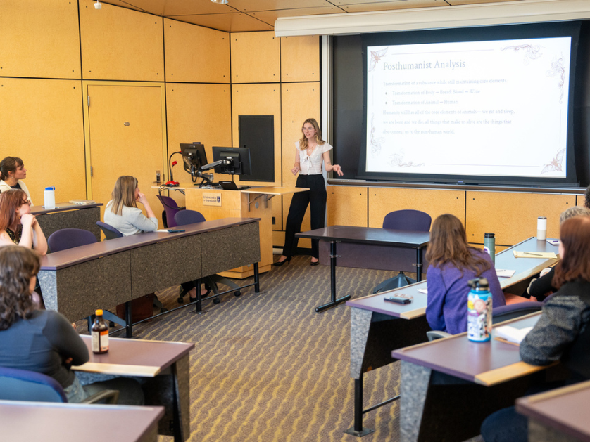 A professor teaching in a classroom with students