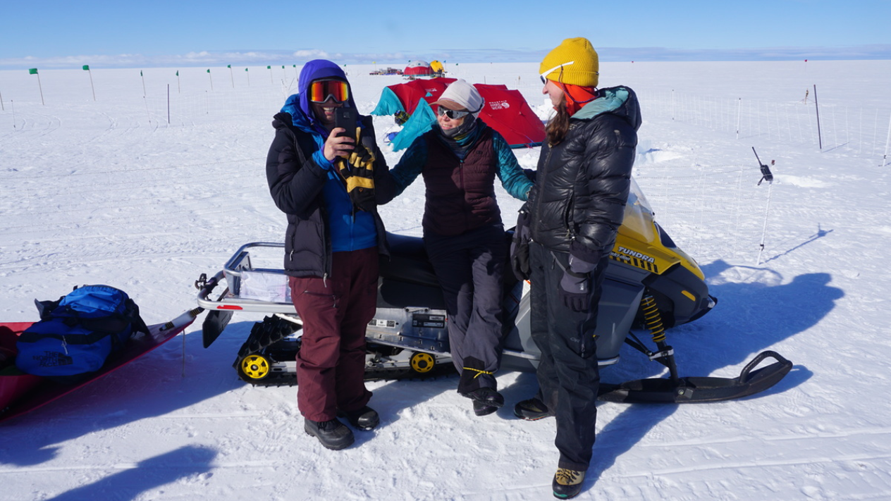 Students stand on a snowy tundra during a research expedition