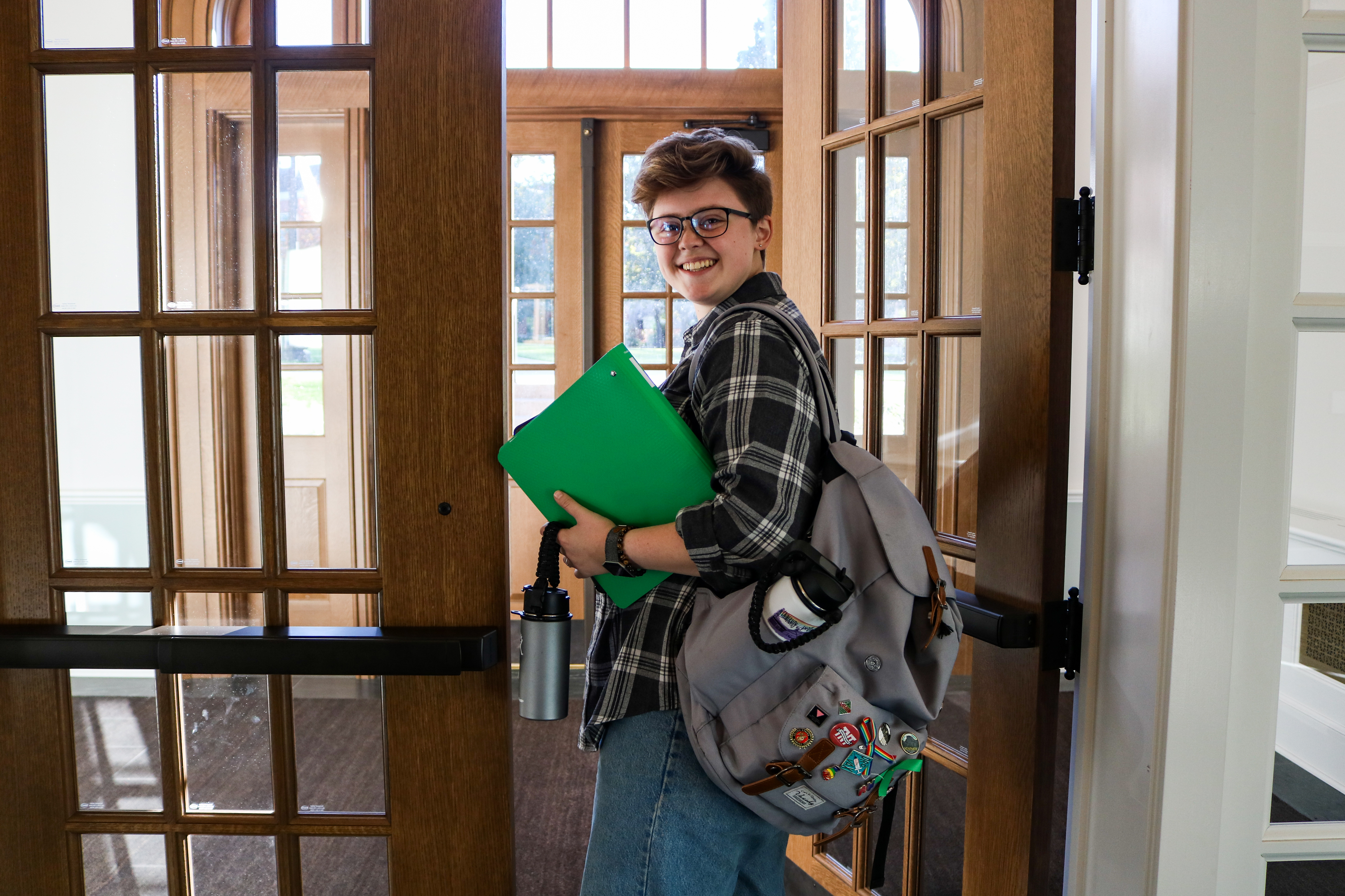 Student looking back through doorway