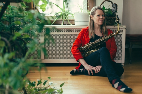 image of Caroline Davis sitting down surrounded by plants 