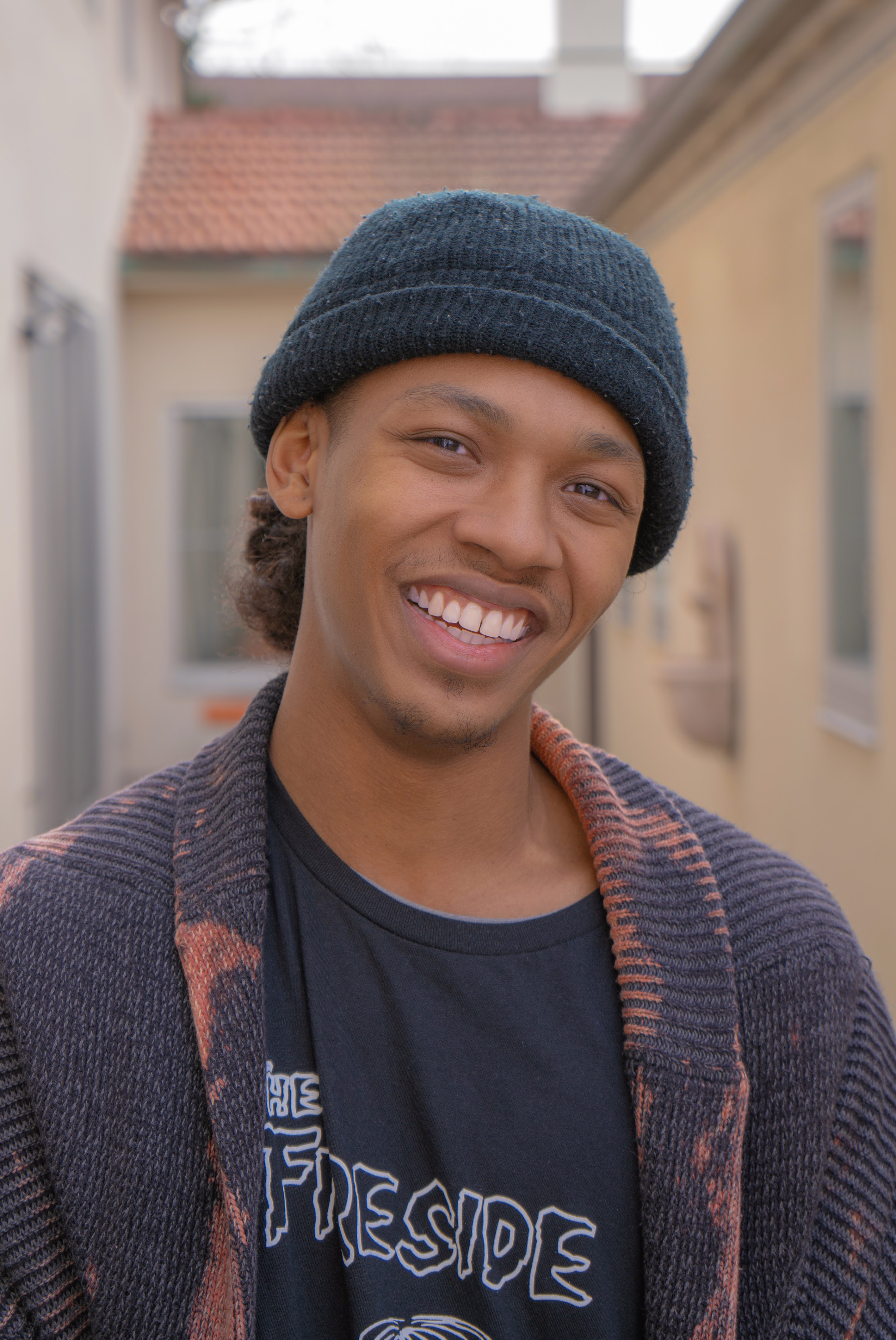 Elijah Fisher, a black man smiling to camera