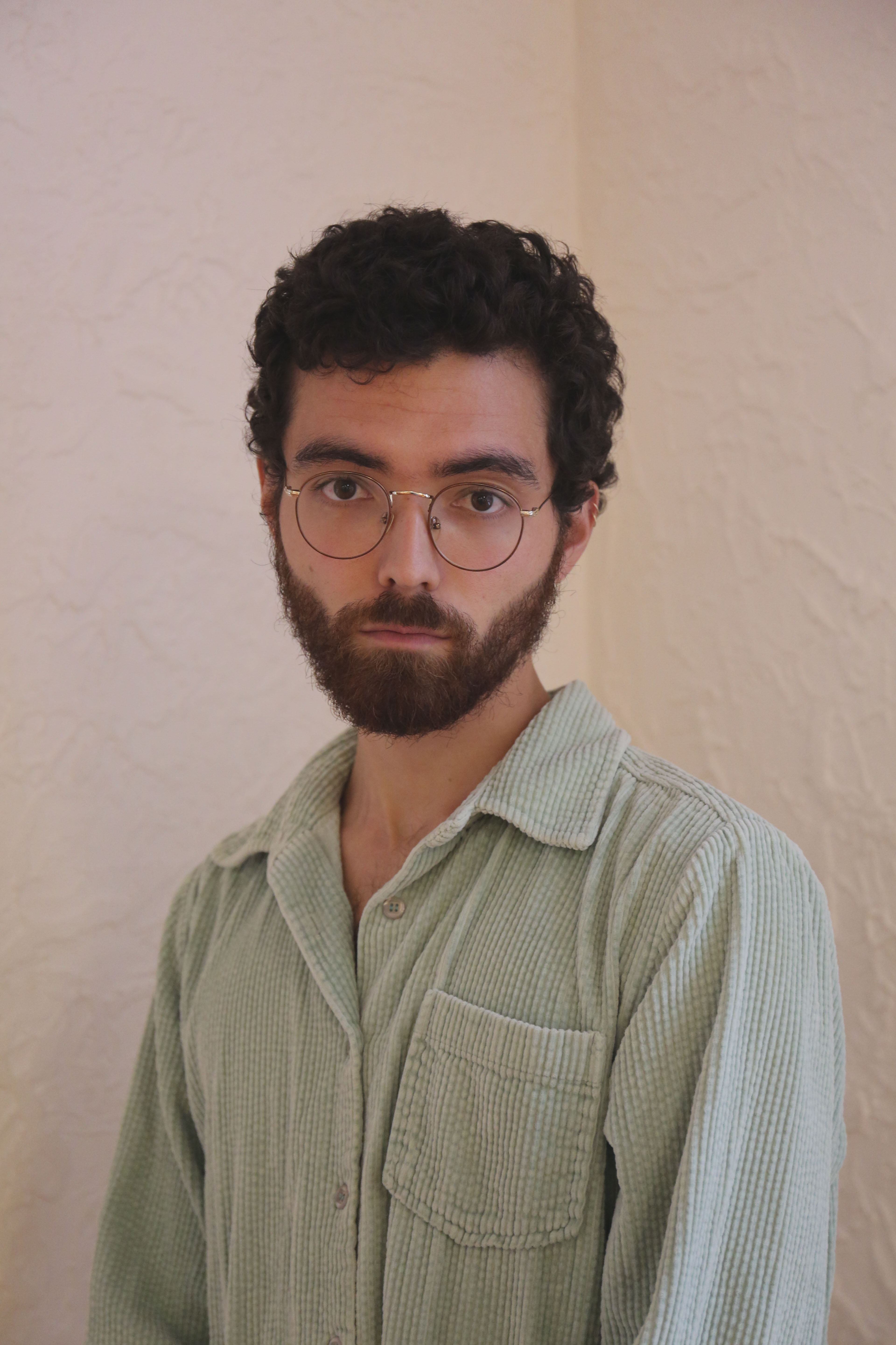 Kai Hynes, a Japanese-American man with brunette hair. He is on-stage and looking off into the distance.